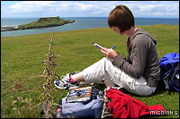 Logging a cache find at a scenic location (this one in Gower)