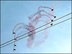 Parachutists display trailing coloured smoke