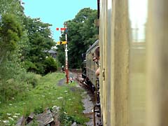 The steam train stopped at the old fashioned signal arm