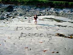 Writing in the sand at Wembury beach