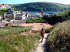Walking down into Hope Cove along the South West Coast Path