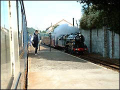 Romney, Hythe and Dymchurch Railway: steam train chuffing through Romney Sands station