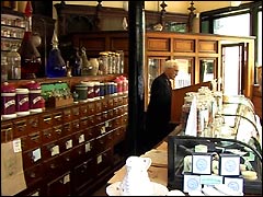 Character costume in the chemist's shop at Blists Hill