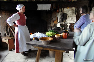 A period re-enactor in the kitchen at Mary Arden's Farmhouse