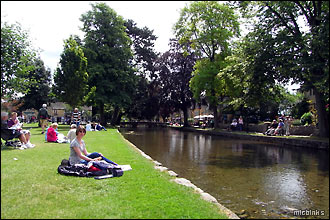 A picnic by the River Windrush on Bourton's village green