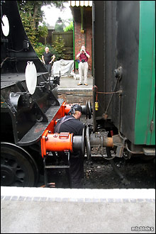 Coupling the steam locomotive to the front of the train on the Watercress Line