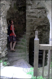 Climbing up a narrow spiral staircase in Carew Castle