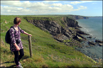Admiring the scenic coastal view along Pembrokeshire's coast path
