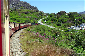 Ffestoniog Railway steam train crossing a level crossing