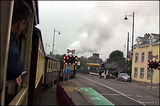 Welsh Highland Railway train crosses the road at Porthmadog